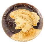 A Sarreguemines majolica charger, moulded with a renaissance style gentleman, and with a brown