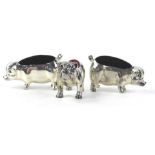 Three modern silver pin cushions, two in the form of cows, the other in the form of a bulldog.