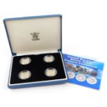 A set of four United Kingdom silver proof pattern collection coins, in blue leatherette case.