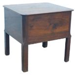 A George III mahogany box commode, the hinged top with rounded corners enclosing a vacant