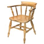 A pine captain's type chair, with spindle turned supports, solid seat on turned tapering legs with H