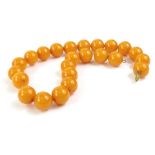 A Butterscotch amber beaded necklace, each bead of spherical form, on wire necklace, approx 15mm