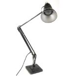 A black angle poise lamp, on a square base, 88cm H.