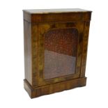 A Victorian walnut pier cabinet, with a moulded cornice with a single glazed door on a plinth
