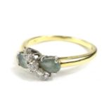 An 18ct gold dress ring, set with two aquamarine stones, and five round brilliant cut diamonds,