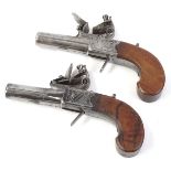 A pair of 19thC flintlock pistols, by Harcourt of Ipswich, each engraved with flags etc., and with a