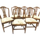 A set of six George III mahogany dining chairs, each with a pierced splat carved with leaves,