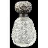 A cut glass scent bottle, with embossed silver mount, marks indistinct, 11cm H.