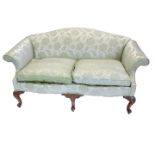 A mahogany sofa in mid 18thC style, upholstered in green damask fabric on carved cabriole legs.
