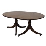 A mahogany extending dining table, in Regency style, the rectangular tope with rounded corners and a