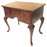 A mahogany lowboy, the rectangular top with a moulded edge, above an arrangement of five drawers