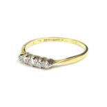 A diamond set dress ring, set with five tiny diamonds, in platinum setting, on yellow metal band,