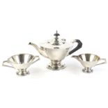 An Edwardian silver three piece tea service, comprising of a teapot, sugar bowl and milk jug, of