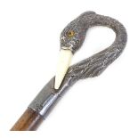 A small mahogany and silver mounted walking cane, the handle modelled as a storks head and neck with