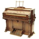 A W Bell & Co Canadian walnut cased harmonium, with fret carved panels, two pedals, etc., 117cm W.