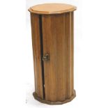 A Victorian oak cylindrical pot cupboard, with a faceted moulded top and similar sides, 37cm dia. (