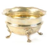 A silver sugar bowl, with a shaped edge, on four legs with paw feet, Birmingham assay, date letter