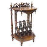 A Victorian style mahogany Canterbury whatnot, the shaped top with turned finales above a