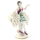 A Dresden crinoline porcelain figure, of a dancing flapper style lady with a green dress, on a
