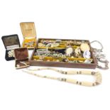 A brown leather jewellery box and contents, to include a silver charm bracelet, a claw bar brooch,