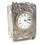 An Edwardian silver cased carriage timepiece, decorated with flowers in the Art Nouveau style,