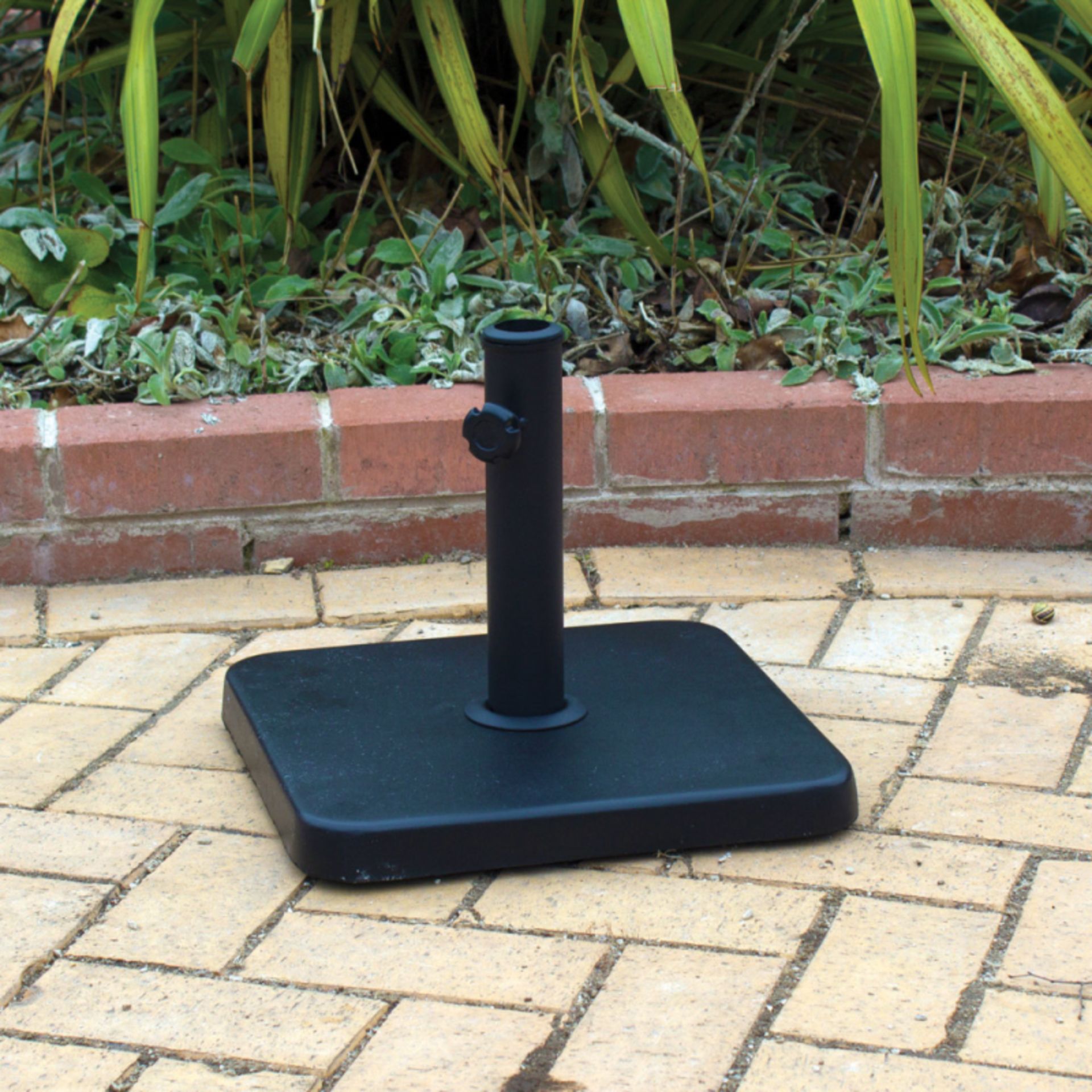 V Brand New Square Parasol Base With A Black Powder Coated Steel Holder On A Concrete Base In