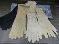 Four pairs of Ladies Vintage gloves. Two cream/white, one pair Dark blue and also a pair of Beaded