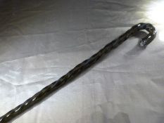 Possible Nailsea glass walking stick - early in a dark green almost black colour