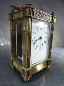 Brass cased Carriage Clock of Architectural style with pillared sides of face. Five bevel glass
