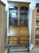 Early oak bureau bookcase with handmade glass panels over two drawers