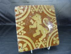 Encaustic terracotta tile decorated with the rampant Lion enclosed by a star and facing left.