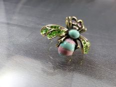 Kitsch bug ring by 'Bohm' in pink and Turquoise enamel with green paste set wings and red eyes,