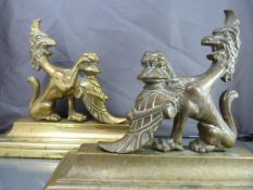 Good Quality pair of Brass fire dogs with Regal griffin with claw foot raised on a helmet. No