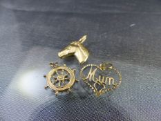 Three Gold Charms - (1) Ships wheel approx 4.8mm in diameter plus full 375 Birmingham hallmarks. (2)