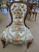 Victorian re-upholstered button back nursing chair on mahogany frame.