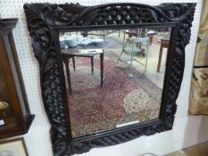 Gothic Revival mirror with foliate carved scrolls of flowers and waves