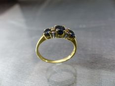 18ct Gold ladies ring set with Sapphires and diamonds (approx 0.05pt). Weight approx 2.5g UK - M1/2