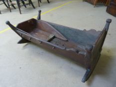 Primitive pine crib with planked sides and a sliding extending end. Carved underside.