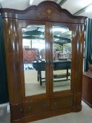 Two door Edwardian mahogany serpentine style wardrobe with inlay. Two mirrored doors reveal the