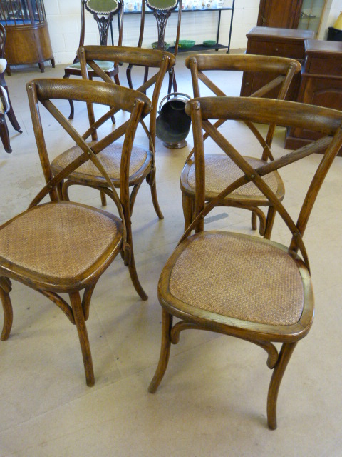 Five dining chairs with Wicker seats and cross stretcher back.