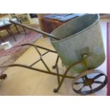 Large oval shaped galvanised water tank on antique cast iron frame with wheels