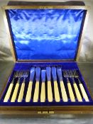 Oak cased set of 12 fish knives and forks with bone handles