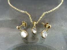 9ct Gold Necklace and Earring set of simple form. Three pendants each set with a clear Rock Crystal.