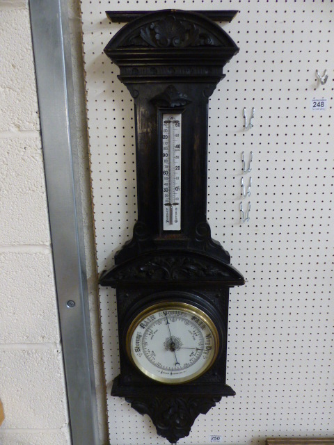 Carved oak Aneroid Victorian Barometer in the architectural style with foliate carved panels. The