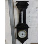 Carved oak Aneroid Victorian Barometer in the architectural style with foliate carved panels. The