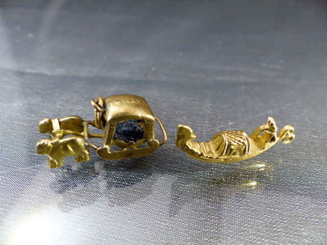 Two Gold Charms - (1) Stamped 'Portugal and Masira in the form of a covered sled pulled by two Ox