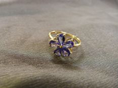 9ct gold ladies ring with mounted flower of five Tanzanite petals