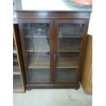 Mahogany glass fronted display cabinet on bun feet