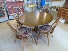 Ercol Ash Windsor style table in the Golden Dawn finish along with 4 matching chairs. Consisting