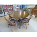 Ercol Ash Windsor style table in the Golden Dawn finish along with 4 matching chairs. Consisting